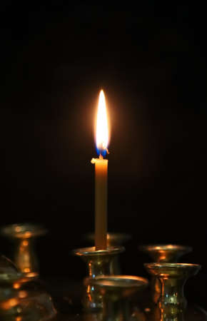 A wax candle is burning in the church.の写真素材