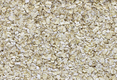 Scattered raw oatmeal, texture.の写真素材