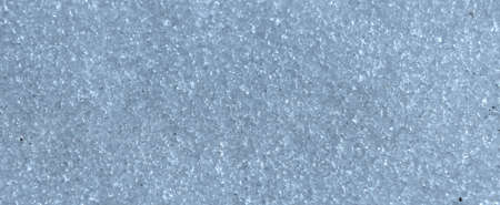 Background texture of icy snow. Grains of ice in the sunlight.の写真素材