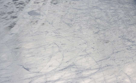 Smooth ice surface and skate scratches.