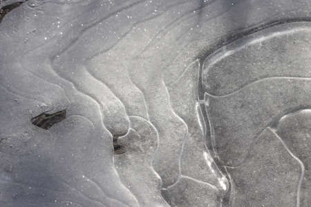 Frozen water outdoors in a puddle. background.の写真素材