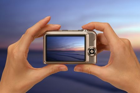 female hands taking picture with a compact digital cameraの写真素材