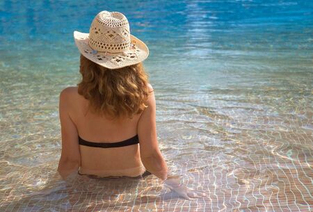 beautiful girl relaxing in a swimming pool