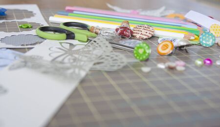 scrapbook colorful background with scissor, color pencils, butterfly and buttonsの写真素材