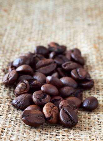 Coffee beans over rustic backgroundの写真素材