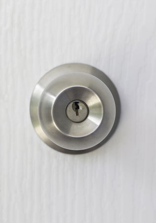 Stainless knob on white door