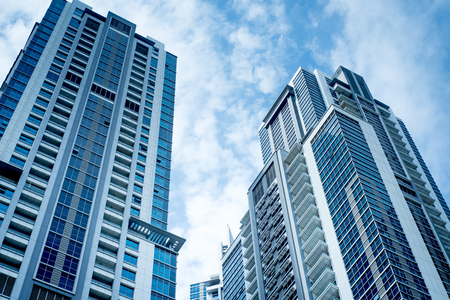 Buildings with blue sky and cloudsの写真素材