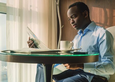 Businessmen Reading Morning Newspaper and Drinking Coffeeの写真素材