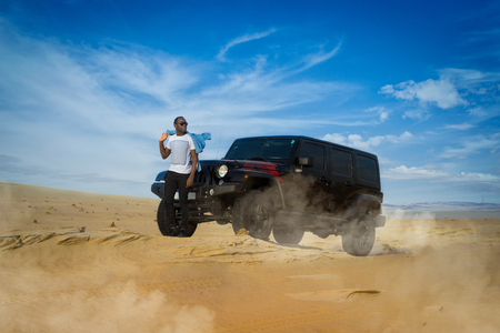 Young guy Posing on desert during offload raceの写真素材