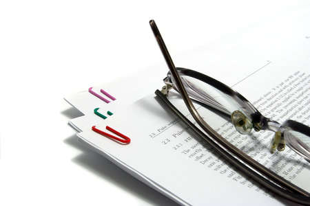 glasses on scientific paper isolated on whiteの写真素材