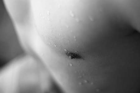 naked man's chest with waterdrops の写真素材