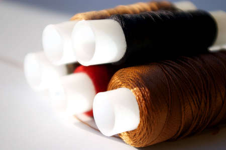 five spools with fiber of different colors