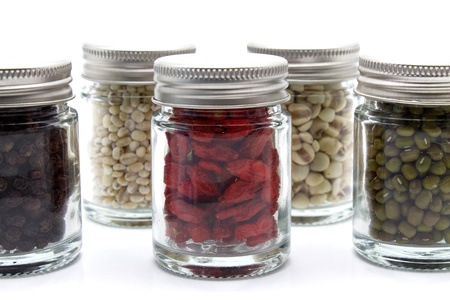 Organic Food; Chinese Wolfberry, Black Pepper, Green Bean, Job s Tears and Barley in Bottle on White Backgroundの写真素材