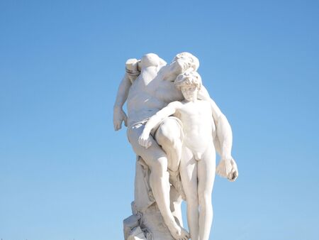 2 sculptures father and son with bright blue skyI found these sculptures in a garden in Paris, France with a park many of sculptures.  the ownership of the original artwork is unknown. の写真素材