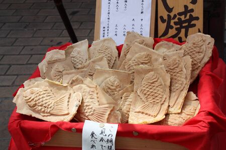 Taiyaki is a Japanese fish-shaped cake. The most common filling is red bean paste that is made from sweetened azuki beans.の写真素材