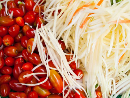 Many Slice papaya and small Tomato for Thai papaya spicy salad or know as Som Tum .の写真素材
