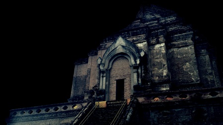 Ancient pagoda at temple in Thailand, Black background.の素材
