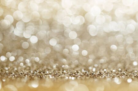 Abstract bokeh golden and yellow colors defocused circular background. Christmas light, new year or season 
greeting background. の写真素材