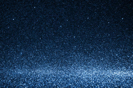 Abstract bokeh dark blue with light background.Navy blue color night light elegance,smooth backdrop,artwork design for new year,Christmas sparkling glittering or special day.Selective focus image.の写真素材