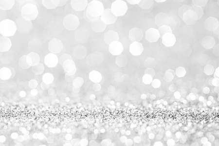 Abstract bokeh silver,white with light background.Grey color night light elegance,smooth backdrop,artwork design for new year,Christmas sparkling glittering or special day.Selective focus image.の写真素材