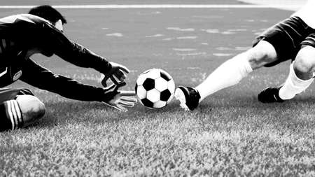 Soccer player in action. Soccer game moment with goalkeeperの写真素材