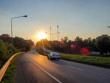 Leaving the city, returning to the countryside at dusk. sunset road view. fast car with motion blur.の写真素材