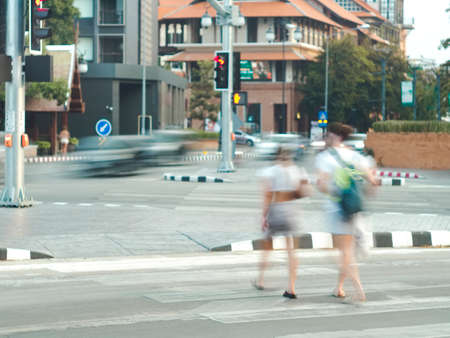 Blurred background. couple crossing the road. crosswalk. Rin Kham Intersection. Chiang Mai Thailand.の写真素材