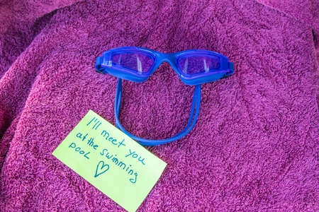 swimming goggles on a bath towelの写真素材