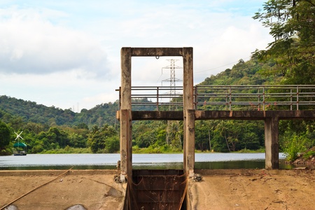 Water pouring through the small dam gates at thailandの写真素材