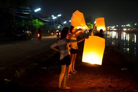 CHONBURI, THAILAND - NOVEMBER 28: Two people holding a flying fire lantern to celebrate the Loy Krathong festival. November 28, 2012 in Hua Hin, Thailand.のeditorial素材