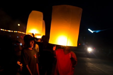 CHONBURI, THAILAND - NOVEMBER 28: Two people holding a flying fire lantern to celebrate the Loy...