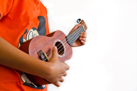 girl playing Ukulele , close up in handsの写真素材