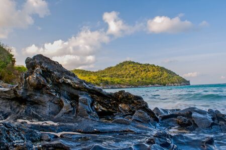 rocks in the sea against beautiful sunsetの写真素材