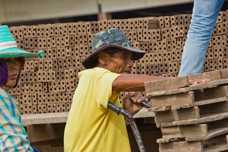 Man laborer lifts the wood of Production of bricks in thailandの写真素材