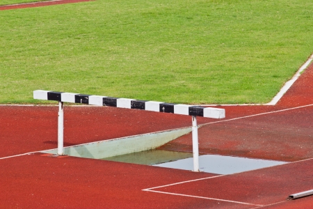 Hurdles on the red running track prepared for competition.の写真素材