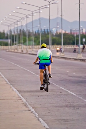 silhouette of a cyclist at sunsetの写真素材
