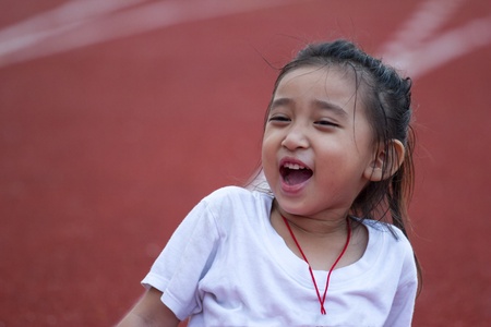 Cheerful girl in sports stadiumの写真素材