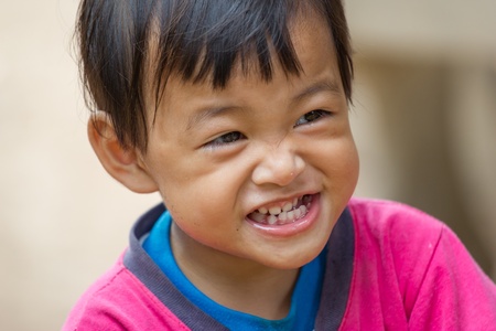 cute little girl smiling in a park close-upの写真素材