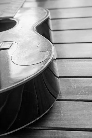 Vintage top guitar on old wood surface.の写真素材