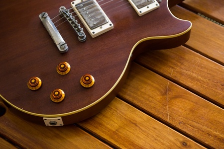 Vintage top guitar on old wood surface.の写真素材