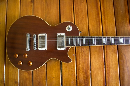 Vintage top guitar on old wood surface.の写真素材