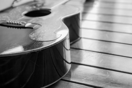 Vintage top guitar on old wood surface.の写真素材