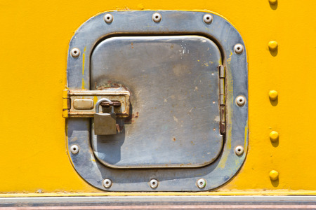 Closeup metal door with lock in grungy style and good texture.の写真素材