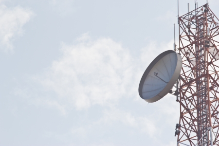 Communications tower with antennas against skyの写真素材