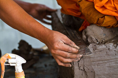 Hands of potter in clay