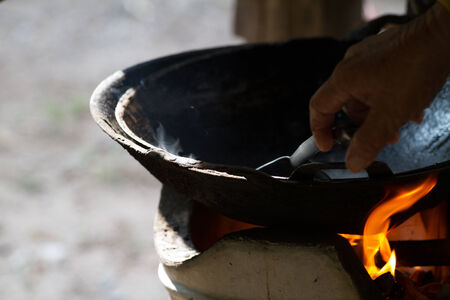 cook on pan at the charcoal brazierの写真素材