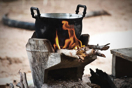 cook on pot at the charcoal brazierの写真素材