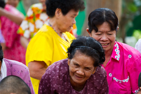 water pouring to hands monk in Songkran festival on april 13,2014 in roi-ed, thailand.のeditorial素材