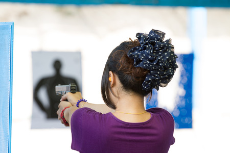 Target practicing with gun In the shooting rangeの写真素材