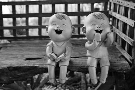 two statuettes of funny boy and girlの写真素材